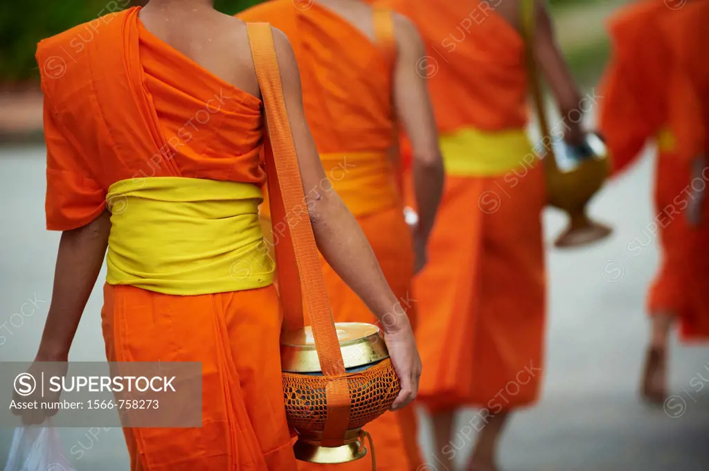Laos, Province of Luang Prabang, city of Luang Prabang, World heritage of UNESCO since 1995, Buddhist monks procession receive offerings