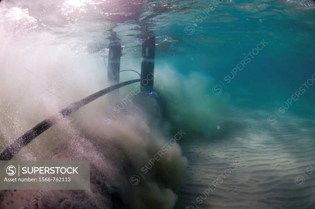 Workers laying a brine discharge pipe from a desalination plant on the seabed to a distance of 300 meter from the shore  High pressure water pumped th...