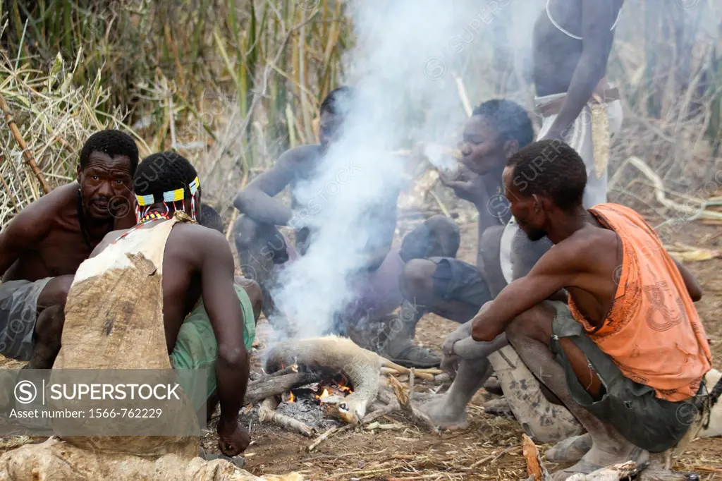 Africa, Tanzania, Lake Eyasi, Hadza tribe  A small tribe of hunter gatherers AKA Hadzabe Tribe  A group of men around a fire