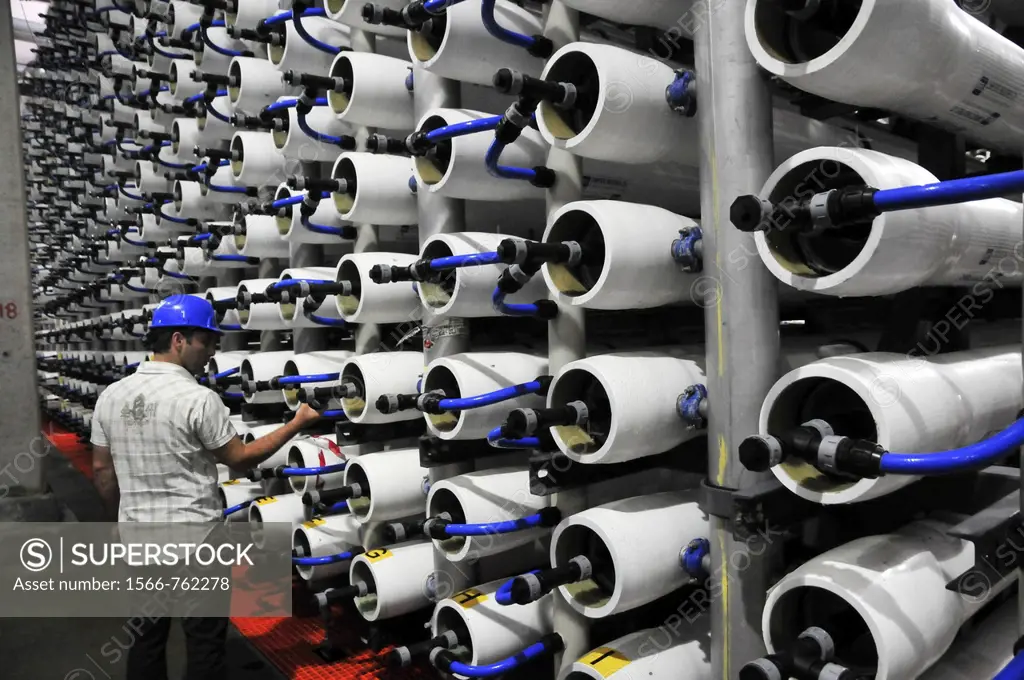 Desalination plant  Engineer inspects the Reverse Osmosis membrane filters  This facility turns salt water into drinking water using the Reverse Osmos...