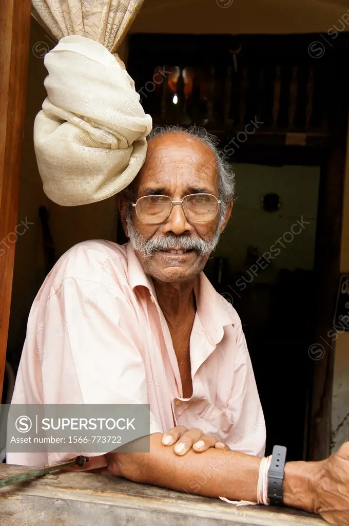elderly man at the window inside the historic Fort in Galle, Sri Lanka