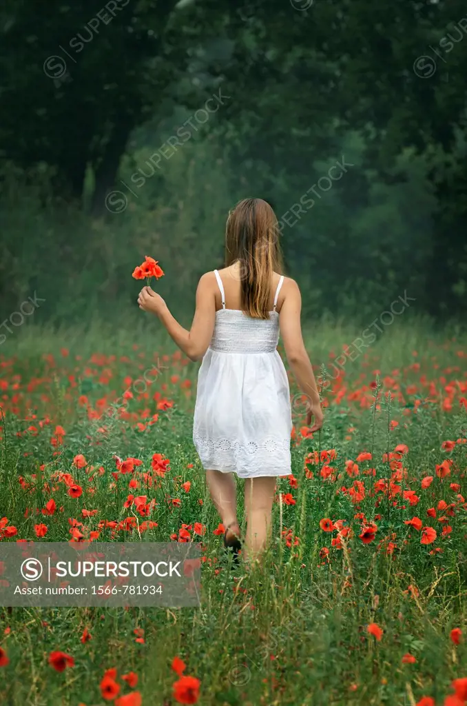 Girl walking at poppies field