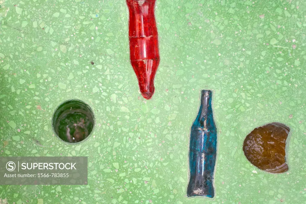 Plastic and glass bottles in concrete