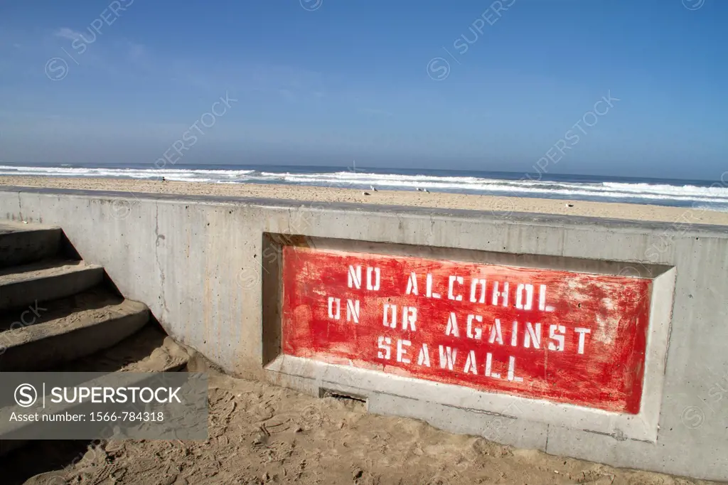 A seawall that warns against having alcohol, Pacific Beach, San Diego, California
