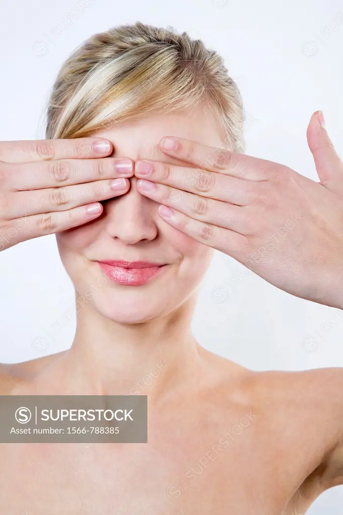 Blond Woman Covering Her Eyes With Her Hands