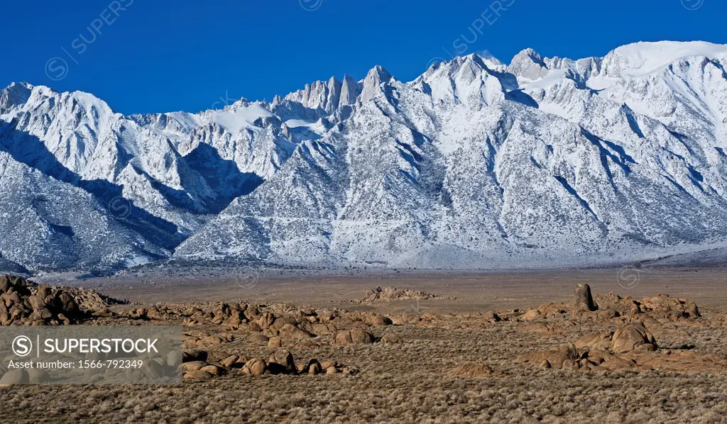 Granite rock formations of Alabama Hills with Mount Whitney and Sierra Nevada mountains in background, California