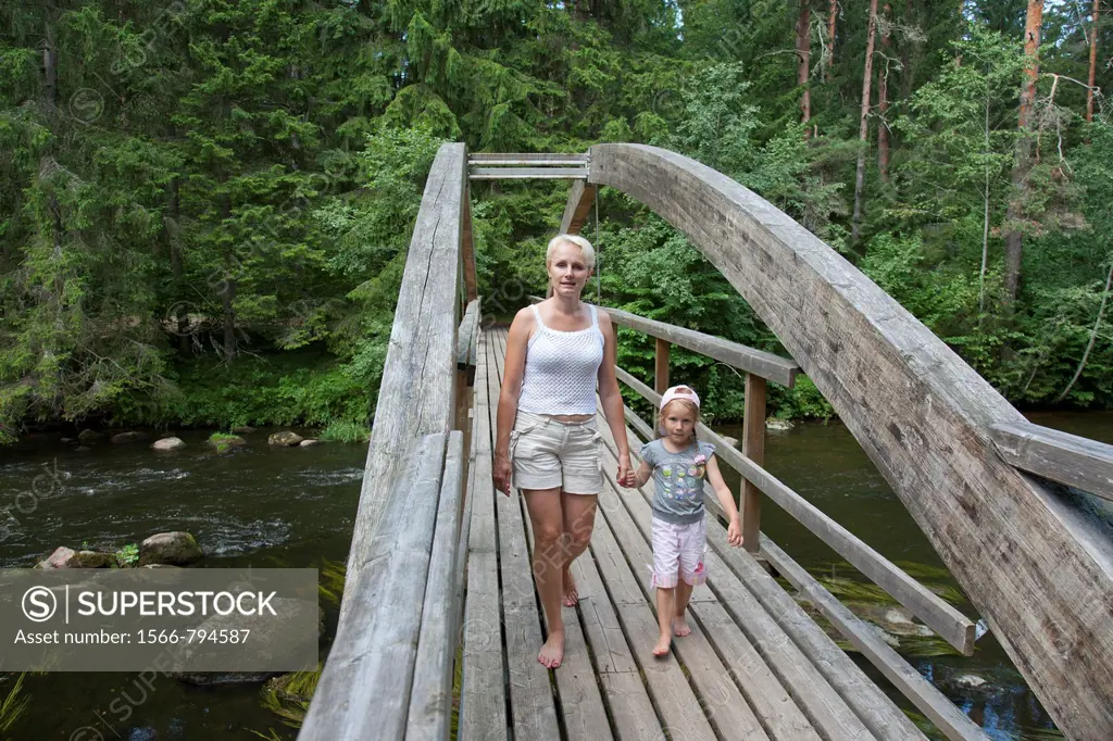 Mother With Kid Walking Over Wooden Bridge Holding Hands, Põlva County, Estonia, Europe