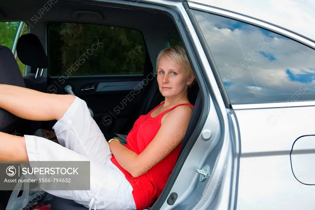 Young women sitting in car on road trip