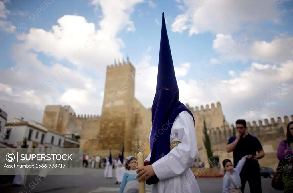 A penitent participates in an Easter Holy Week procession in front of the Alcazar fortress in Carmona, Seville province, Andalusia, Spain, April 19, 2...