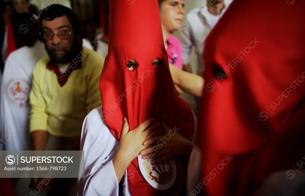 Penitents stand inside a church waiting to start an Easter Holy Week procession in Carmona, Seville province, Ansalusia, Spain, May 19, 2001  The proc...