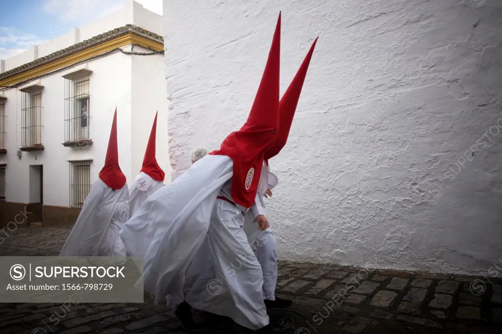 Penitents walk in a street before an Easter Holy Week celebrations in Carmona village, Seville province, Andalusia, Spain, April 19, 2011