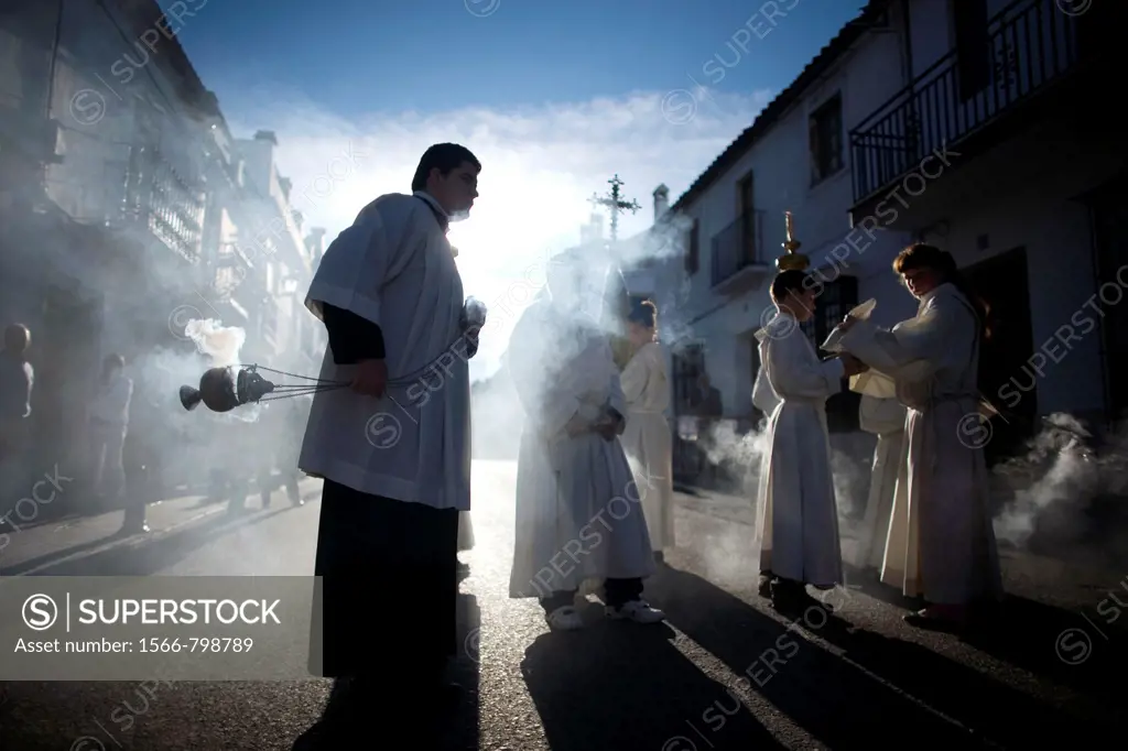 An acolyte spreads incense during an Easter Holy Week procession in Prado del Rey, Andalusia, Spain, April 24, 2011