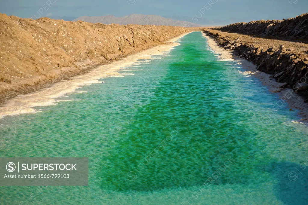 Green canals of liquid Calcium Chloride drying in the desert outside Amboy, CA