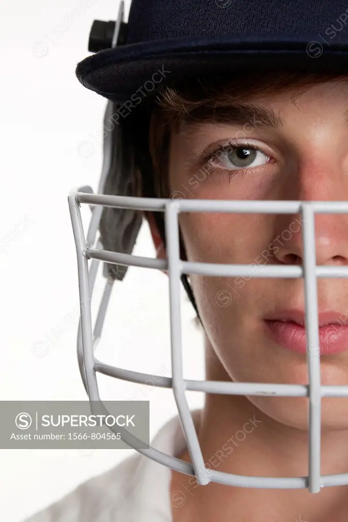 Portrait of teenage cricketer in protective helmet and visor