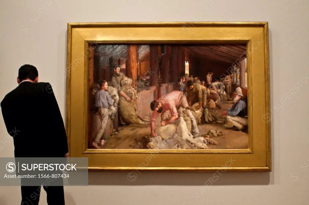 National Gallery of Victoria, Visitor checking the title of Tom Robert painting Shearing the Rams Melbourne, Victoria, Australia