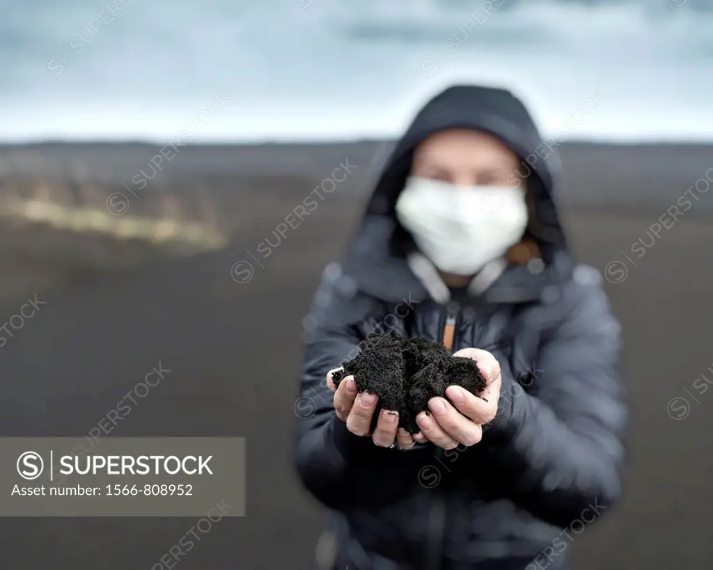 Woman holding new ash from recent Grimsvotn volcanic eruption, Iceland  Skeidararsandur outwash plains covered with ashfall  Eruption began on May 21,...