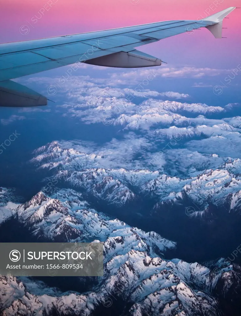 A view the snowy Swiss and French Alps from above at sunset