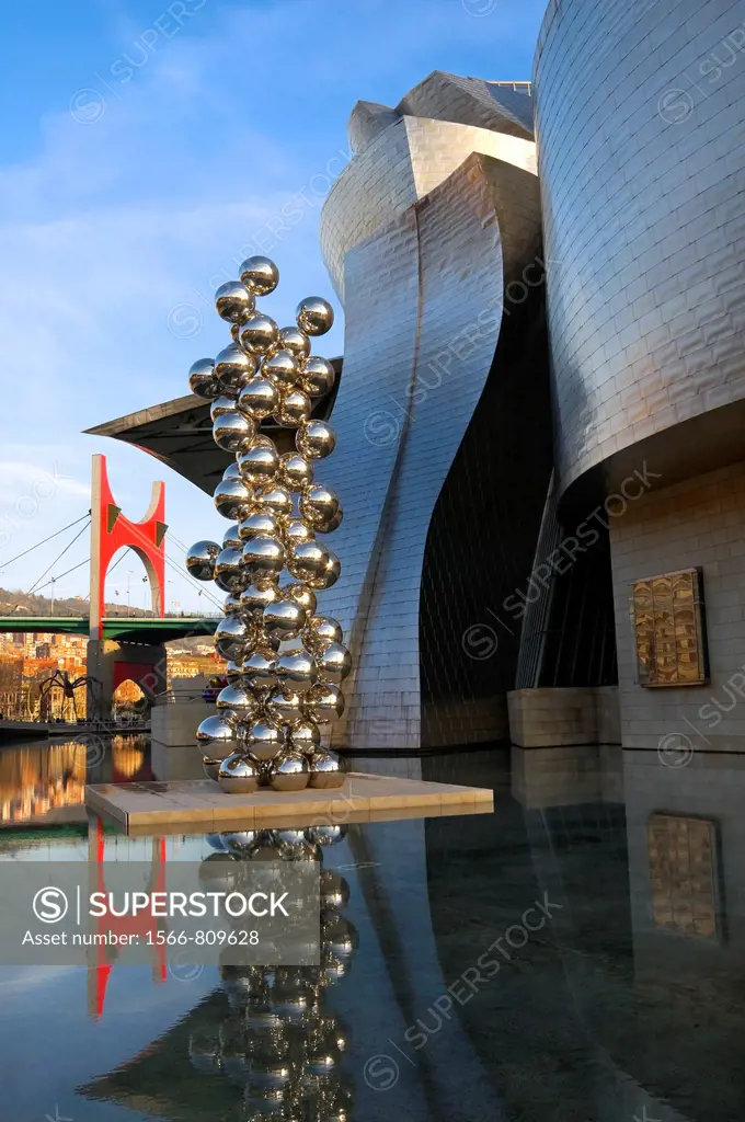 Guggenheim Museum and the scuplture Tall tree and the eye” by Anish Kapoor with La Salve” bridge on the bagkground, Bilbao, Vizcaya, Basque Country,...