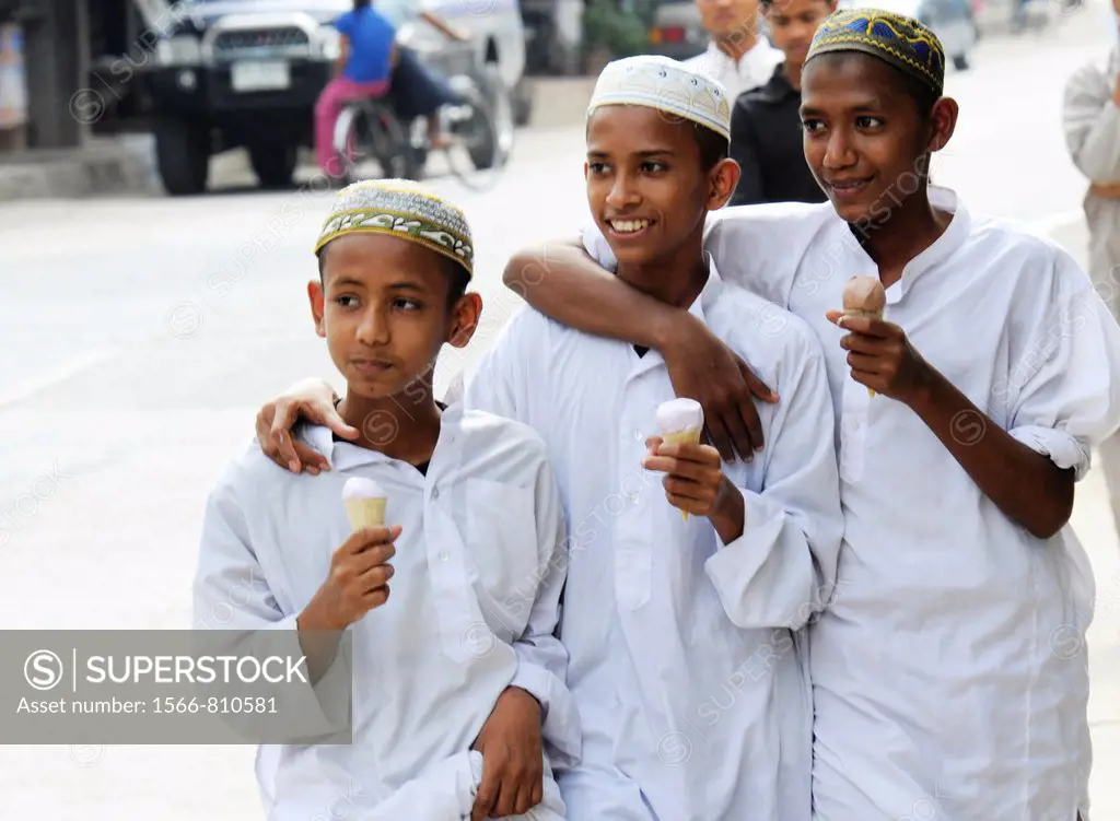 muslim boys eating ice cream on their way to the muslim school, mae sot , northern thailand