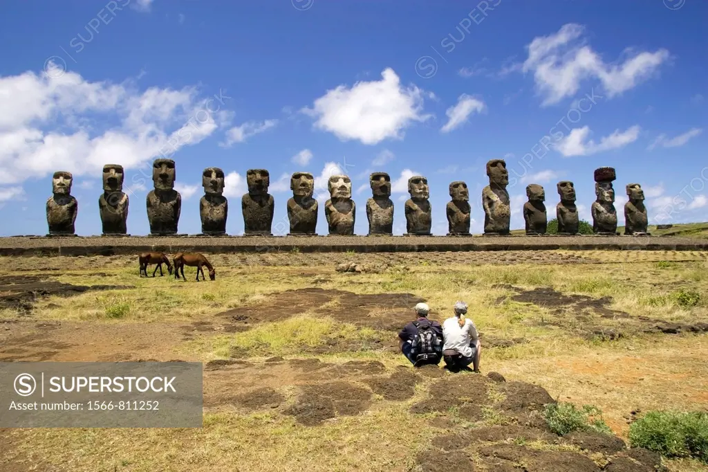 Couple sitting at Ahu Tongariki Moai - Easter Island, Chile