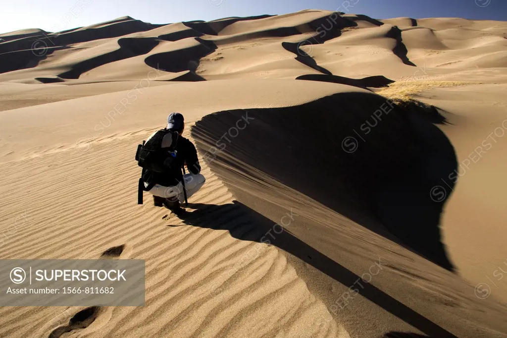 Backpacker on dunes - Great Sand Dunes National Park and Preserve - near Mosca, Colorado