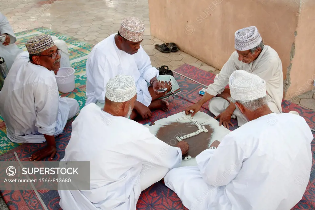 Oman, Muscat, Mutrah, men playing dominoes