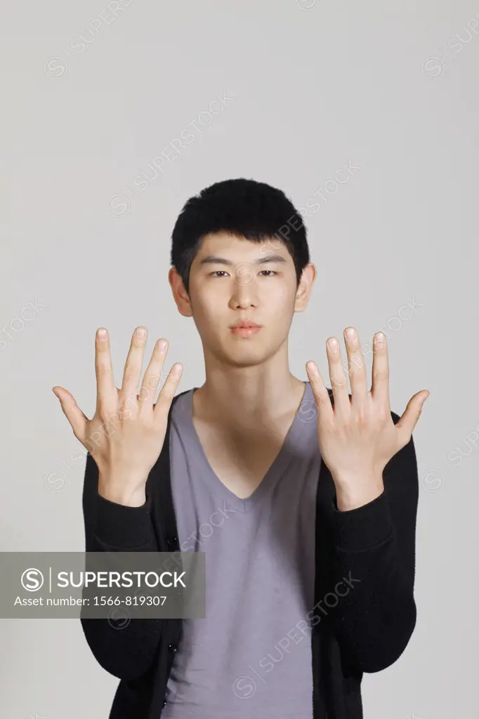 Studio shot of Korean man, showing hands