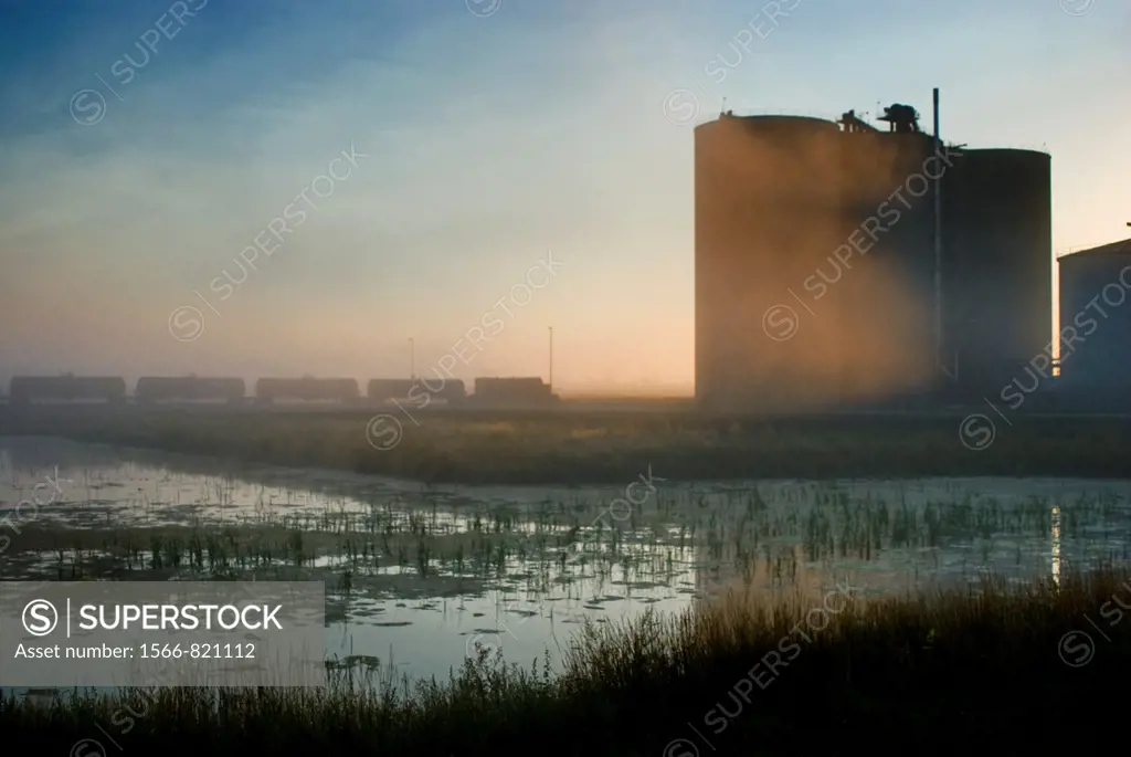 Corn silos and railroad tank cars loaded with ethanol ready for shipment from ethanol plant, Richardton, North Dakota