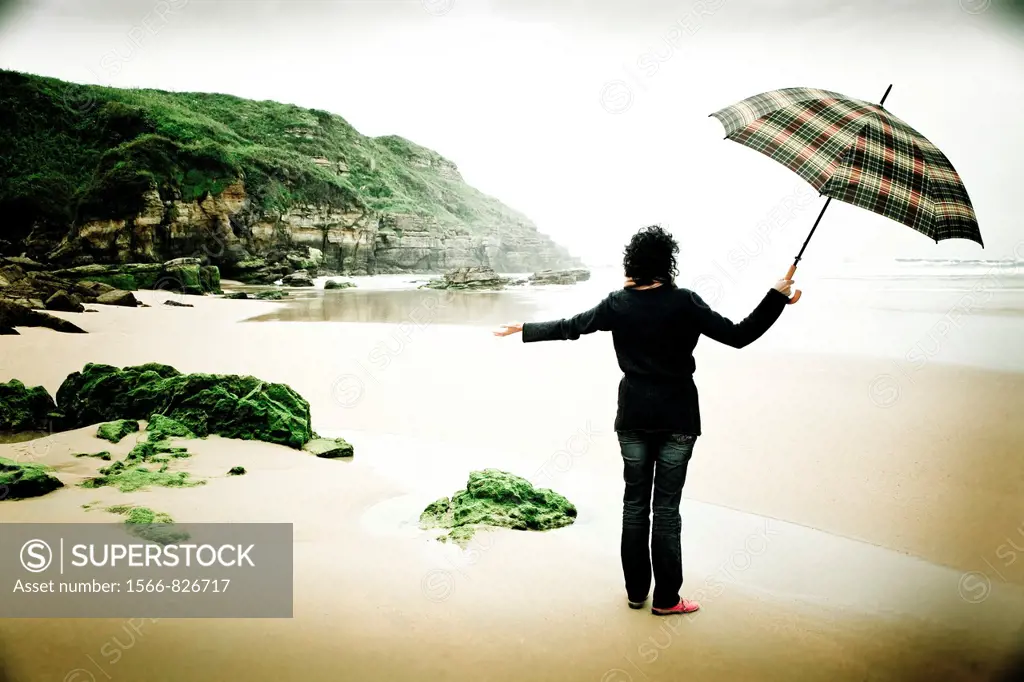 young woman on a beach wih an umbrella