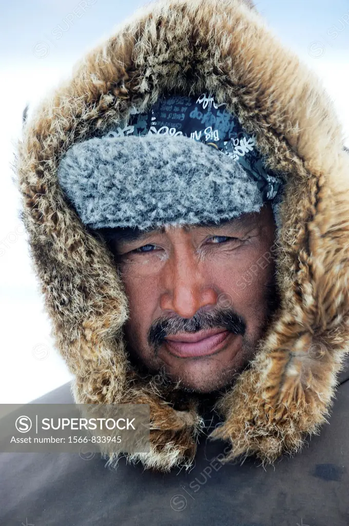 Portrait of Inuit hunter with a fur hat, Floe Edge, Arctic bay, Baffin Island, Nunavut, Canada