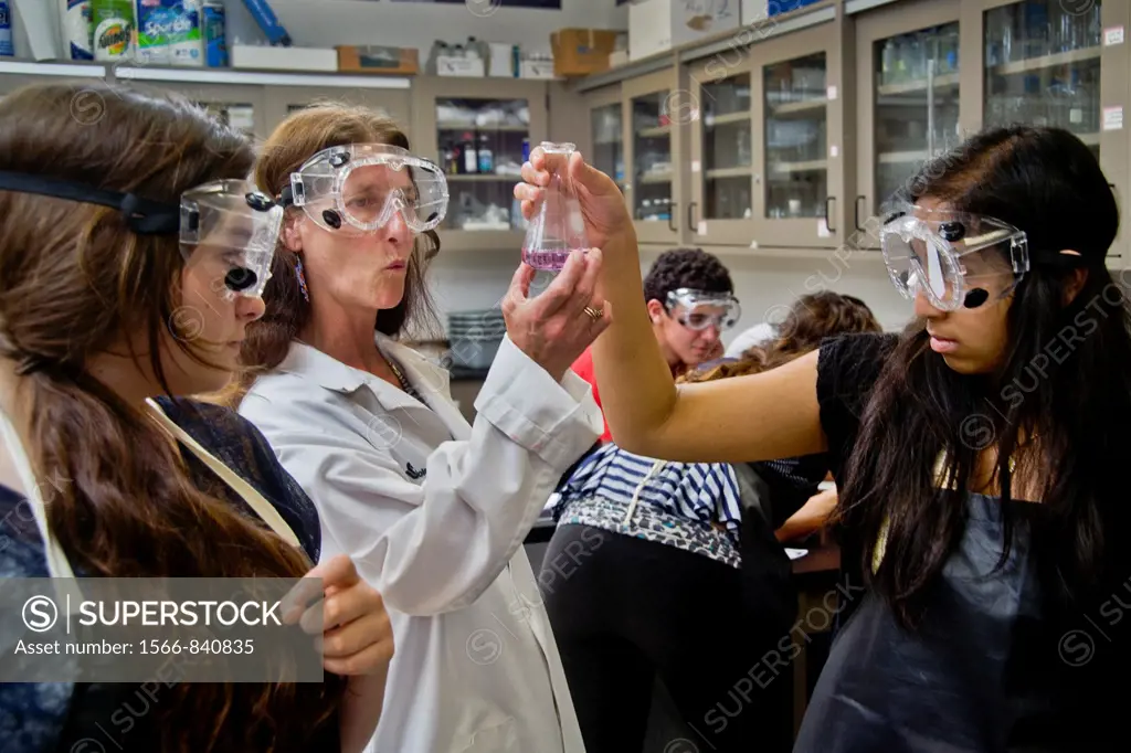 A high school chemistry teacher San Clemente, CA, inspects the results of her students´ experiment using titration, a method of quantitative chemical ...
