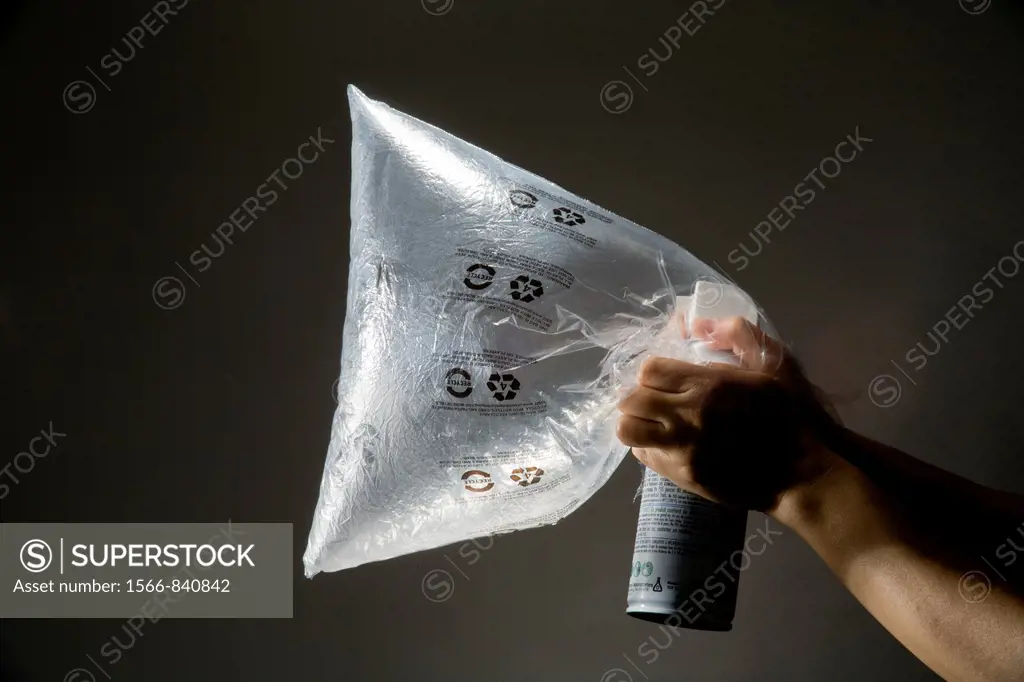 A plastic bag is filled by an aerosol inhalant gas can for illegal use as a drug