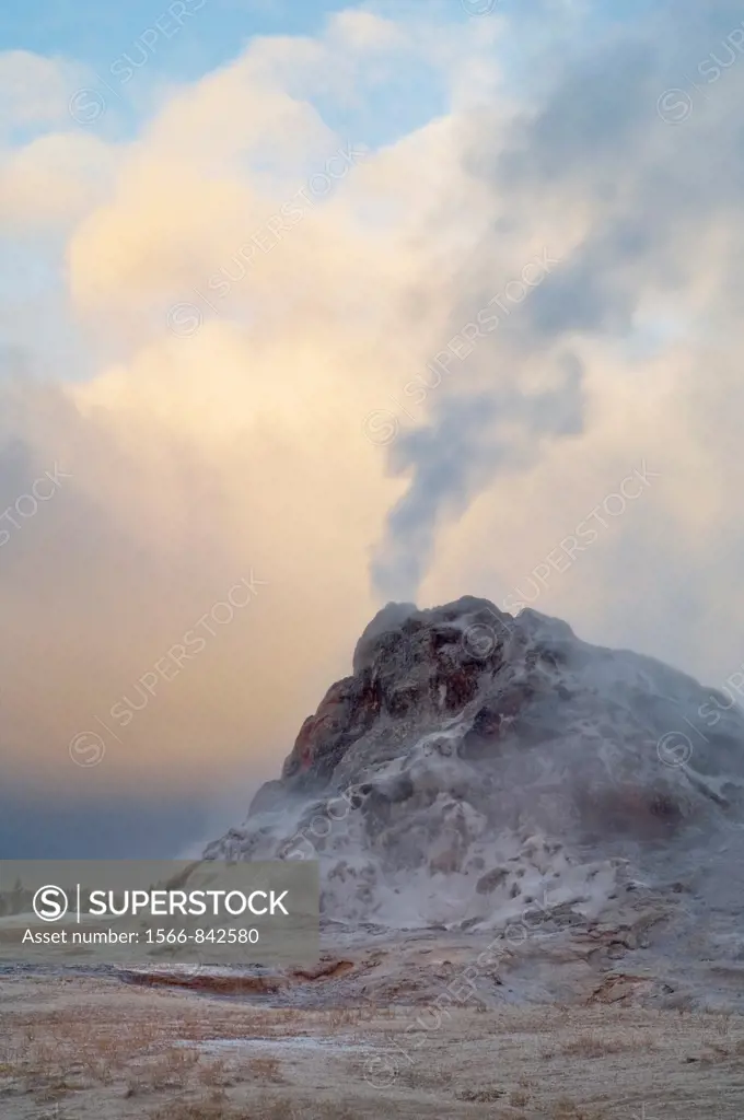 Steam venting from White Dome Geyser and autumn storm clouds at sunrise, Yellowstone National Park, Wyoming