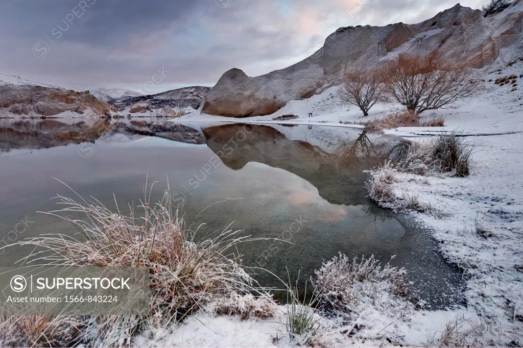 Winter dawn reflection, Blue Lake, St Bathans historic goldfields town, Central Otago, New Zealand