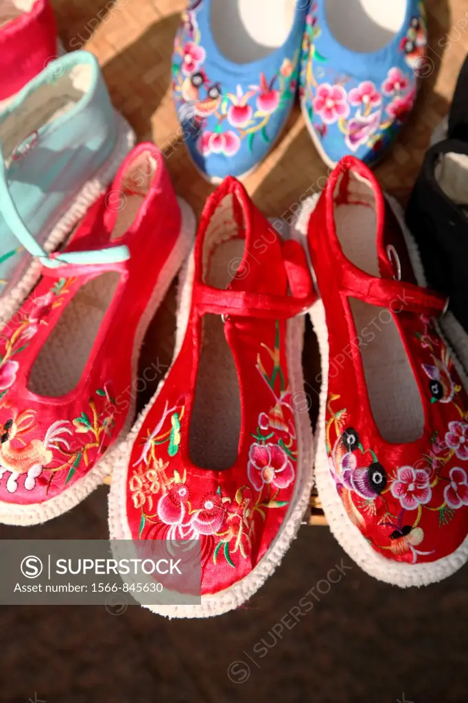 Traditional style hand made embroidered shoes for sale on old town street  Town of Guandu  Kunming  China.