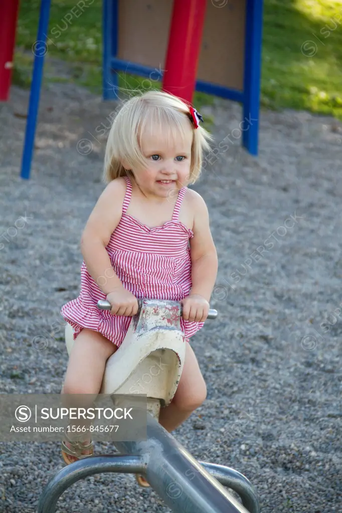 A female caucasian toddler, 1-2 years old, playing at the park in Fairfield, Washington, USA.