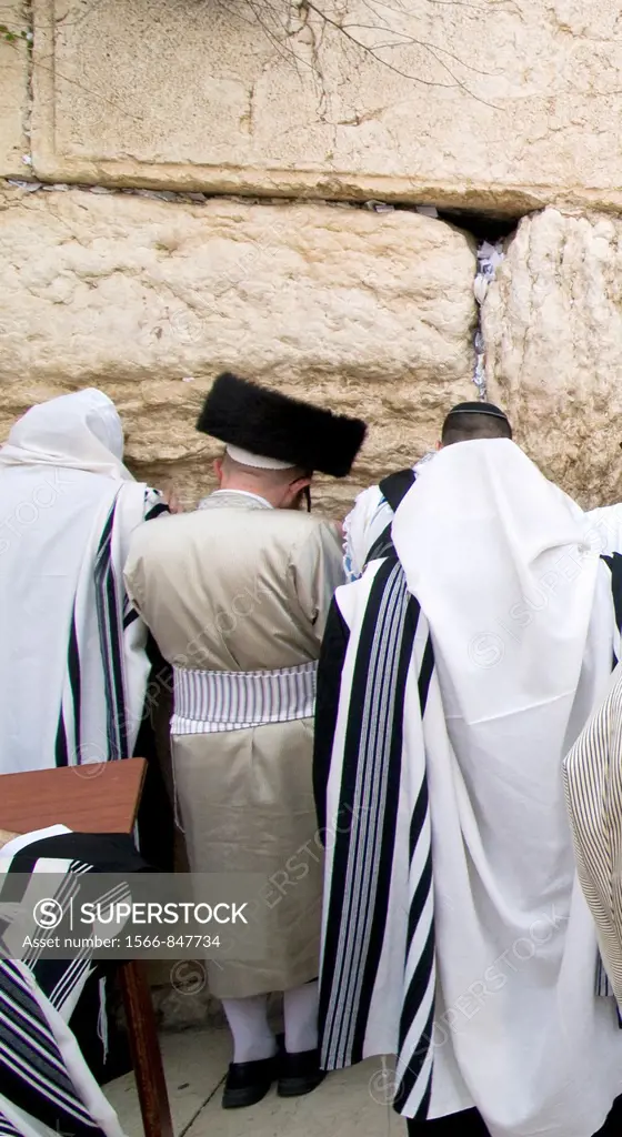 Hasidic Orthodox Jews praying by the wailing wall in the old city of Jerusalem.