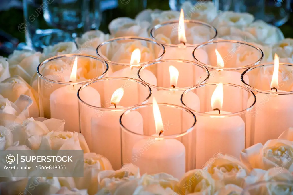 Group of candles surrounding by wreath of roses