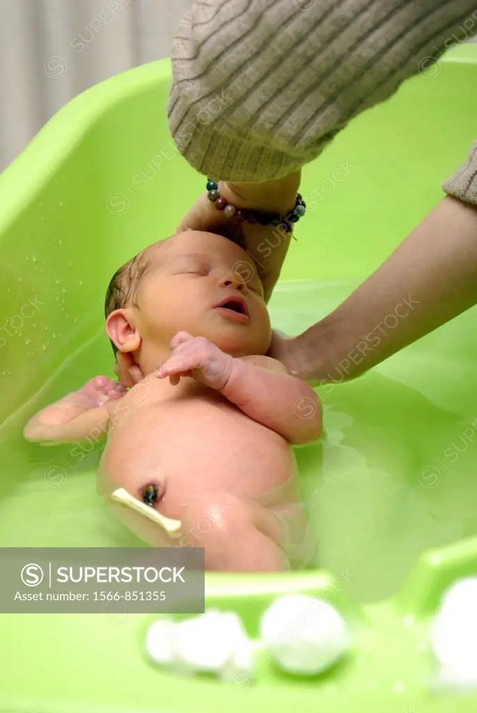 A newborn baby being bathed