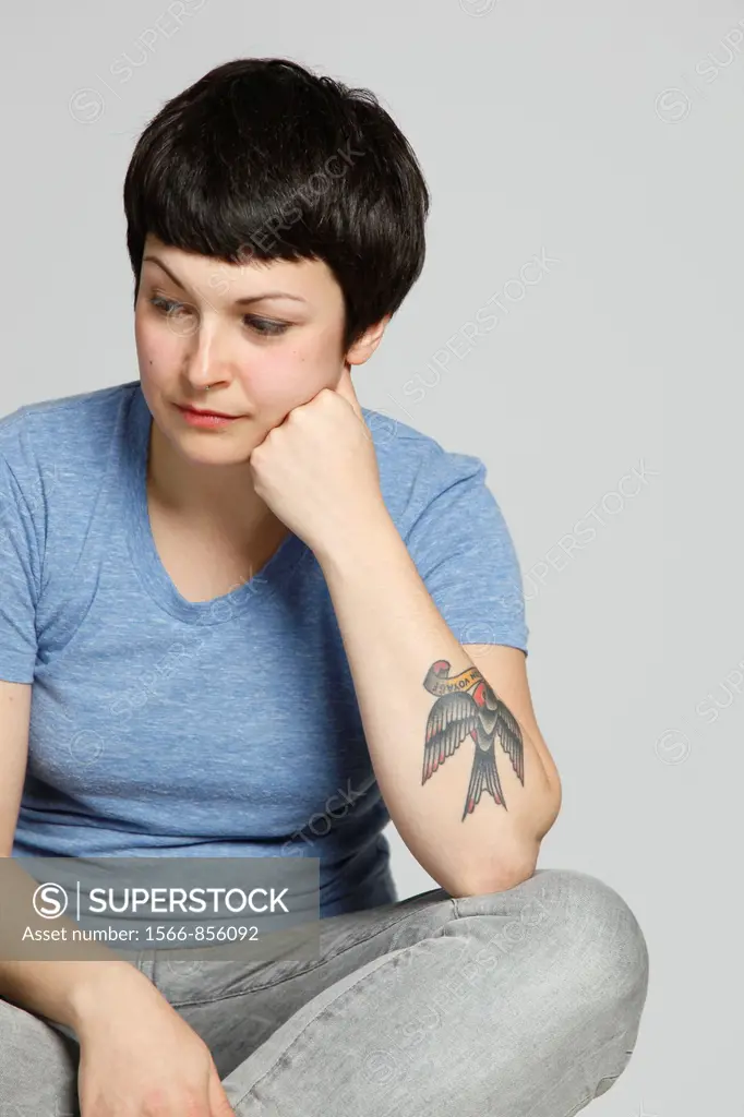 Studio shot of young tattooed woman