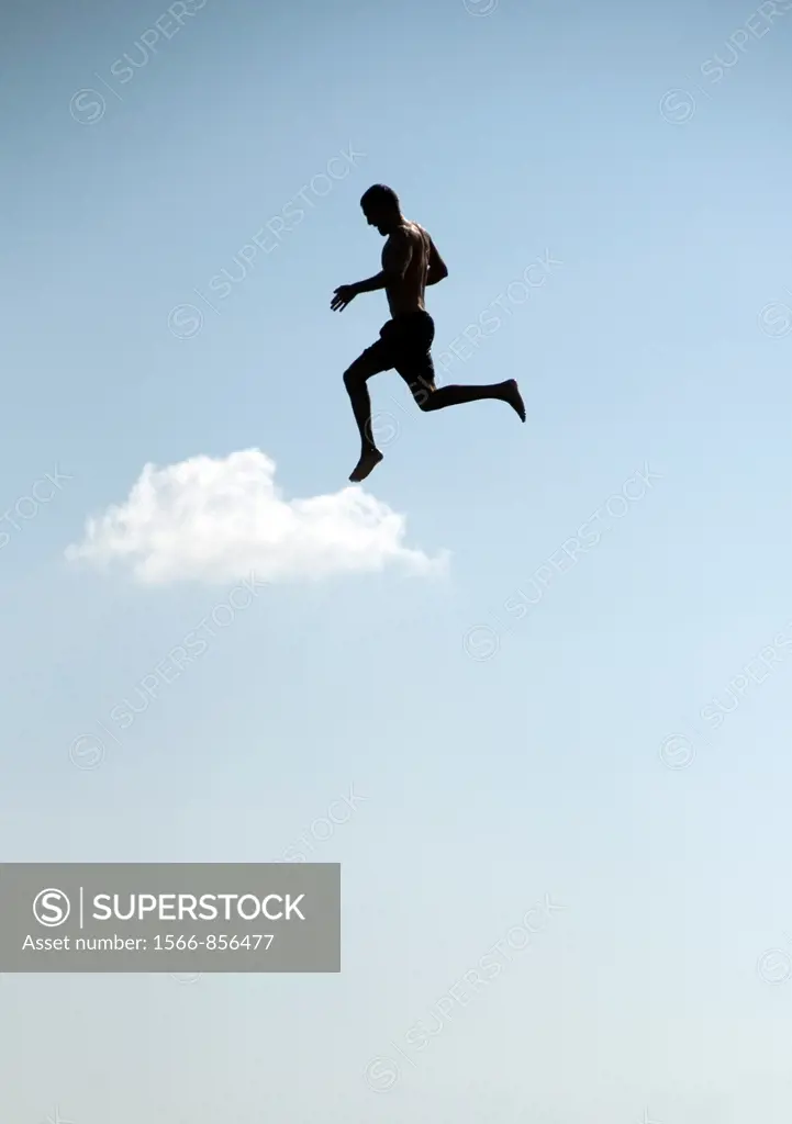 young man jumping from the tower to the jumps in the water, beach on the Geneva Lake in Geneva called ´Paquis plage´, Geneva, Switzerland