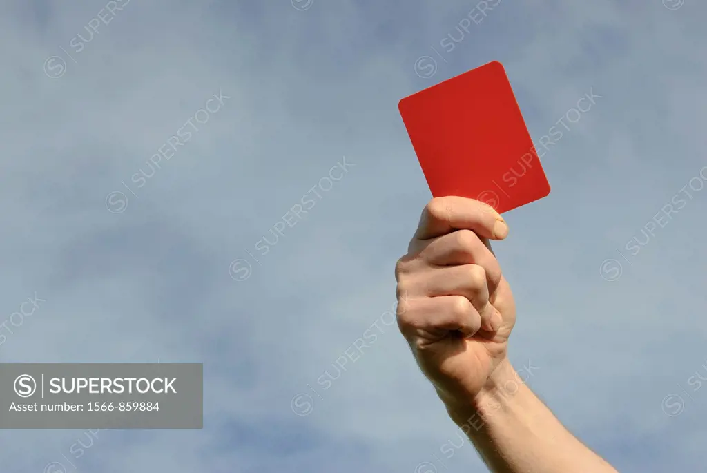 Hand of referee waving red card