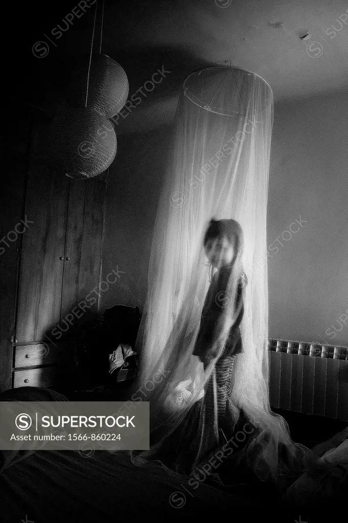Child under a mosquito net