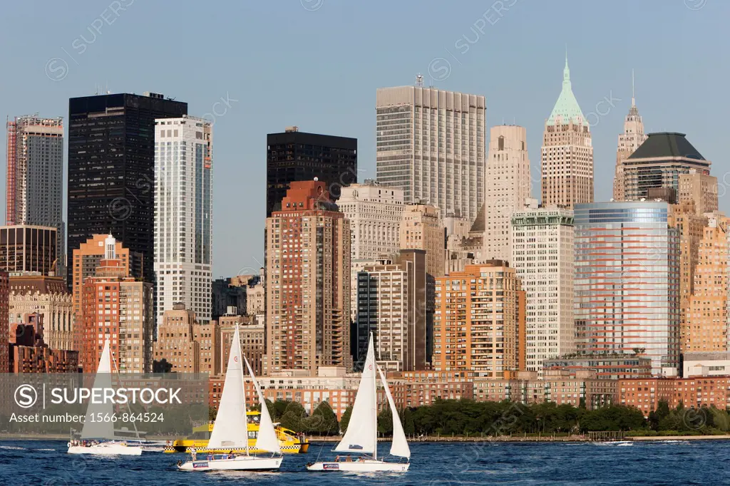 Sailboats on the Hudson River, with the lower Manhattan financial district of New York City as a backdrop, as seen from Liberty State Park, New Jersey...