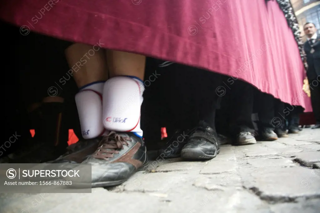 Feet of float bearers during a Holy Week procession, Seville, Spain