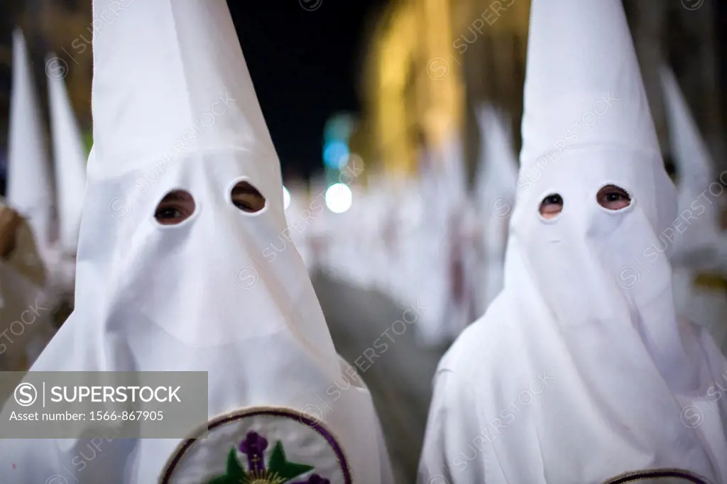 Close up of young hooded penitents, Holy Week, Seville, Spain