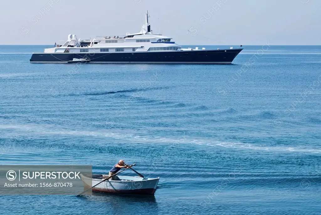 Luxury yacht and poor fisherman in contrast in the Gallipoli Bay
