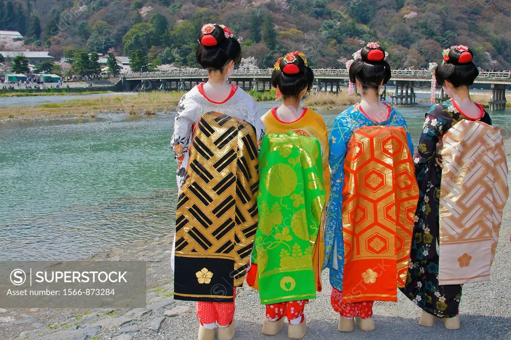 Tourists dressed up as geisha in front of the famous Togetsu-kyo bridge over the Katsura river, rear view