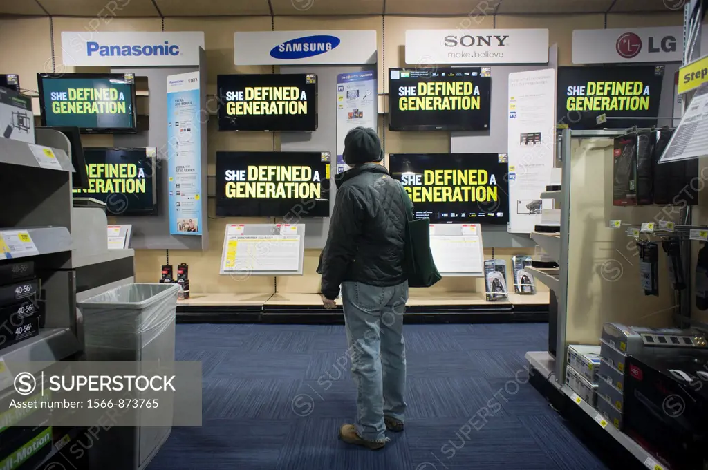 A shopper is dumbfounded by the selections as she browses the flat screen television display at a Best Buy electronics store in New York