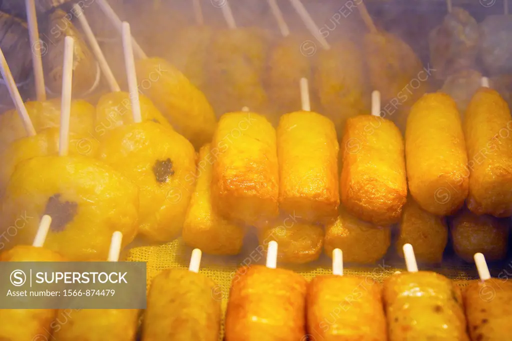 A steamy view of a Japanese snack on a stick in Nishiki market
